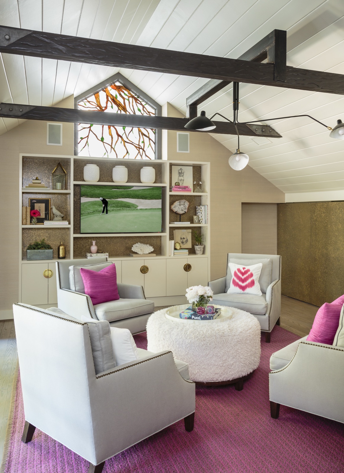 Upstairs loft sitting room with vaulted shiplap ceiling, dark exposed beams, gable-window built-ins and custom millwork. Brentwood Layton Drive residence by ESRL Development.