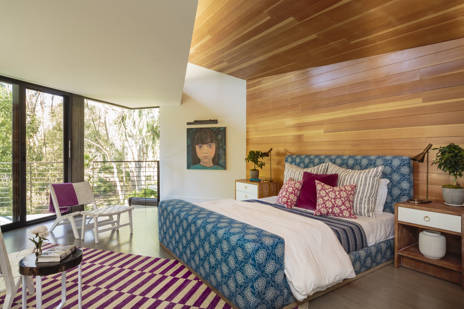 Master bedroom in the Brentwood Layton Drive residence, full cedar plank accent wall and ceiling, custom upholstered bed, floor-to-ceiling glass opening to a private balcony. ESRL Development.