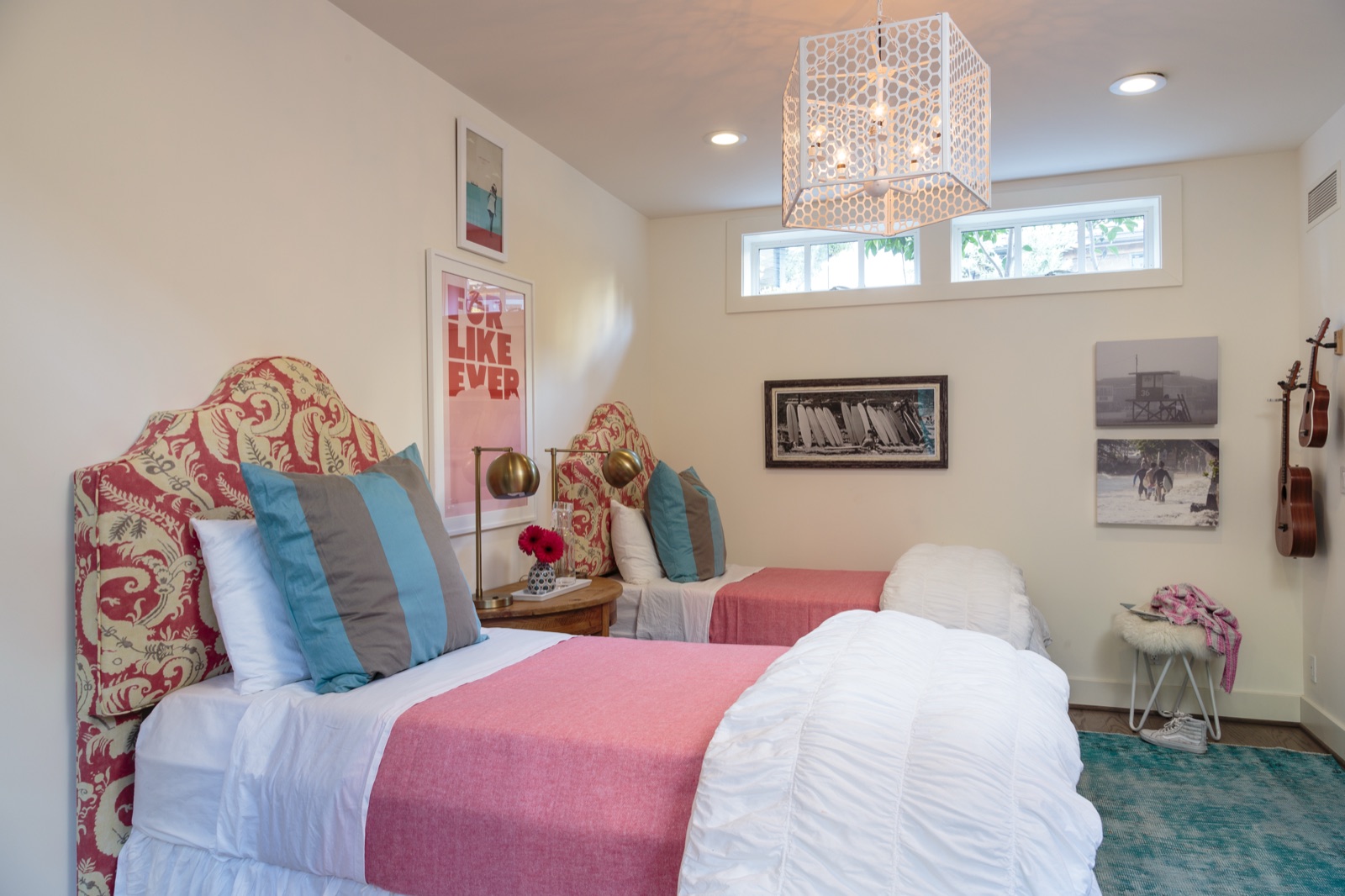Twin-bed guest room in the Brentwood Layton Drive residence, paisley upholstered headboards, custom chandelier, clerestory windows under a soft white ceiling. ESRL Development.