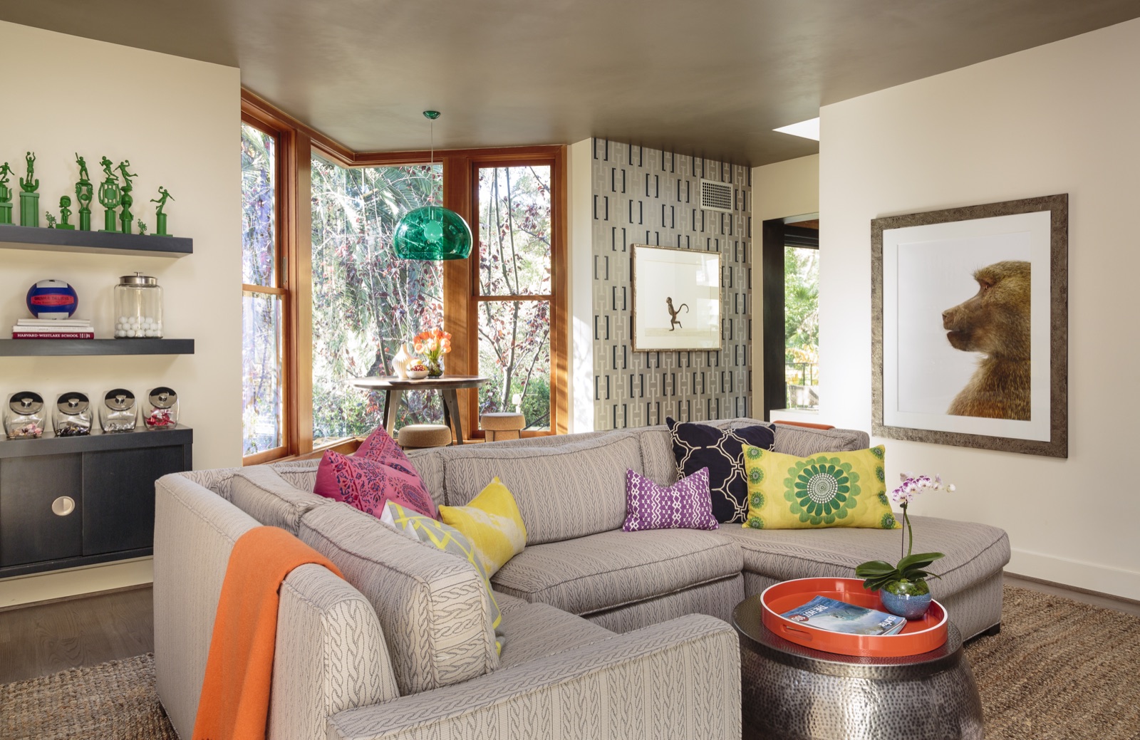 Upstairs family lounge with bronzed plaster ceiling, custom bay window, floating walnut shelving and L-shaped sectional. Brentwood Layton Drive residence by ESRL Development.