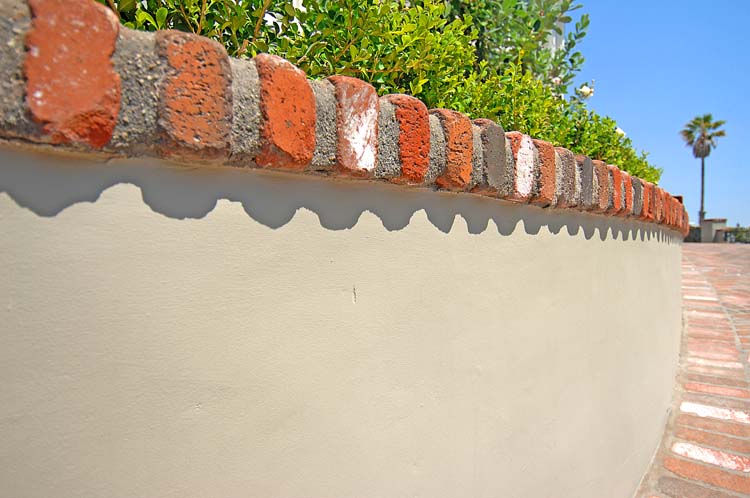 Detail of the hand-carved scalloped stucco garden wall with reclaimed brick capping. Hollywood Hills, ESRL Development. Craftsmanship by the principal.