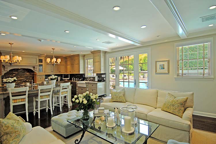 Family room flowing into the kitchen and out through French doors to the pool, open plan luxury living. Hollywood Hills residence.