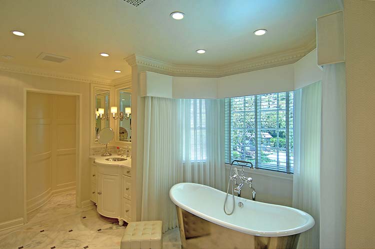 Master bathroom with silver clawfoot soaking tub, curved bay window, marble checkered floor, white custom vanity. Hollywood Hills residence, ESRL Development.